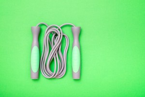 High Angle View Of Jumping Rope On Green Background