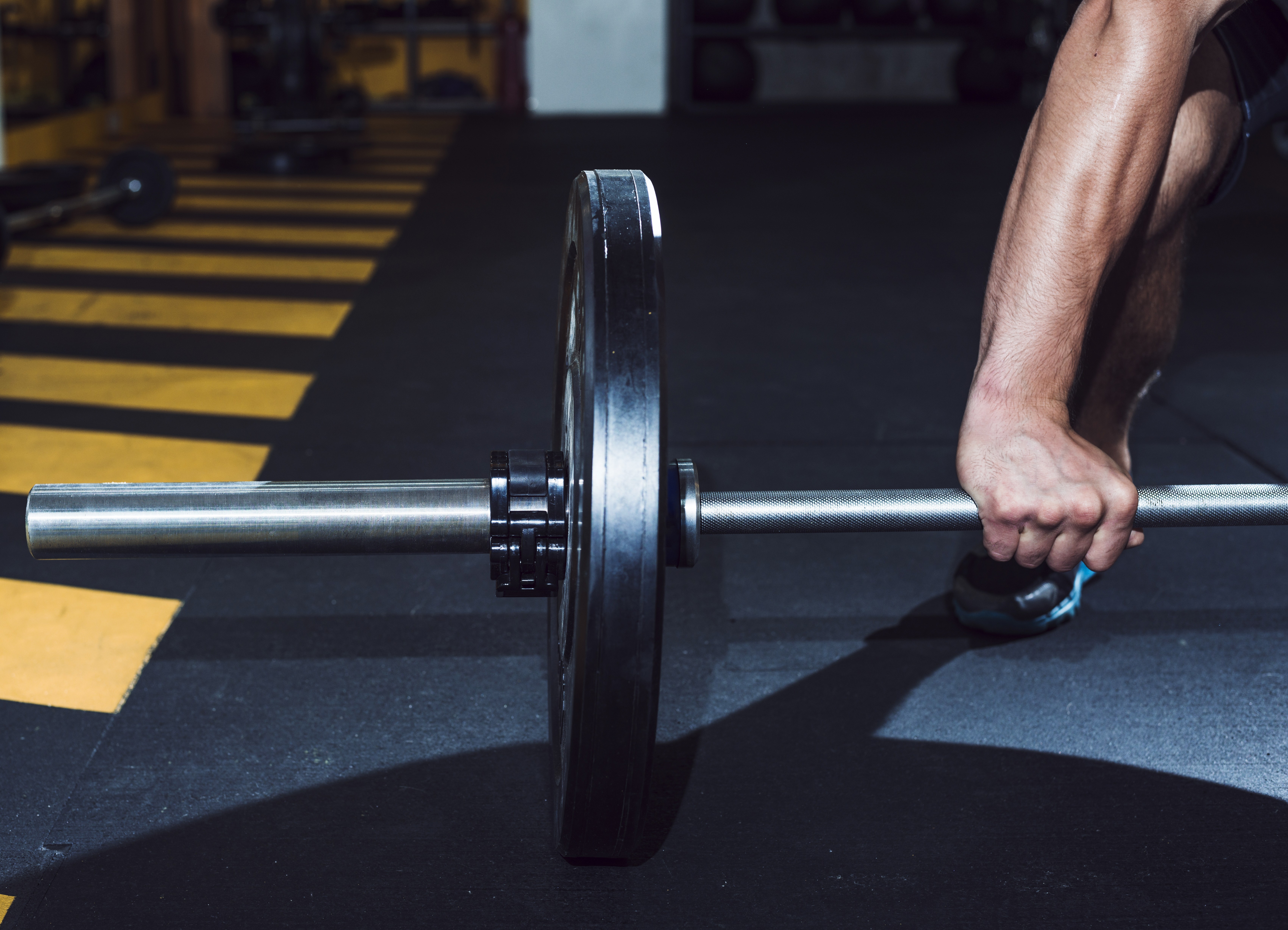 close-up-man-s-hand-lifting-barbell